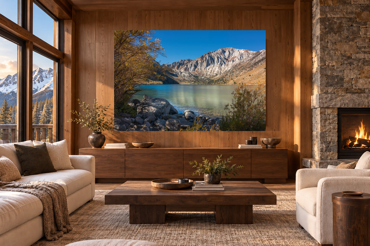 A Quiet Radiance displayed as a frameless acrylic print above a wood console in a warm Mammoth Lakes chalet living room.