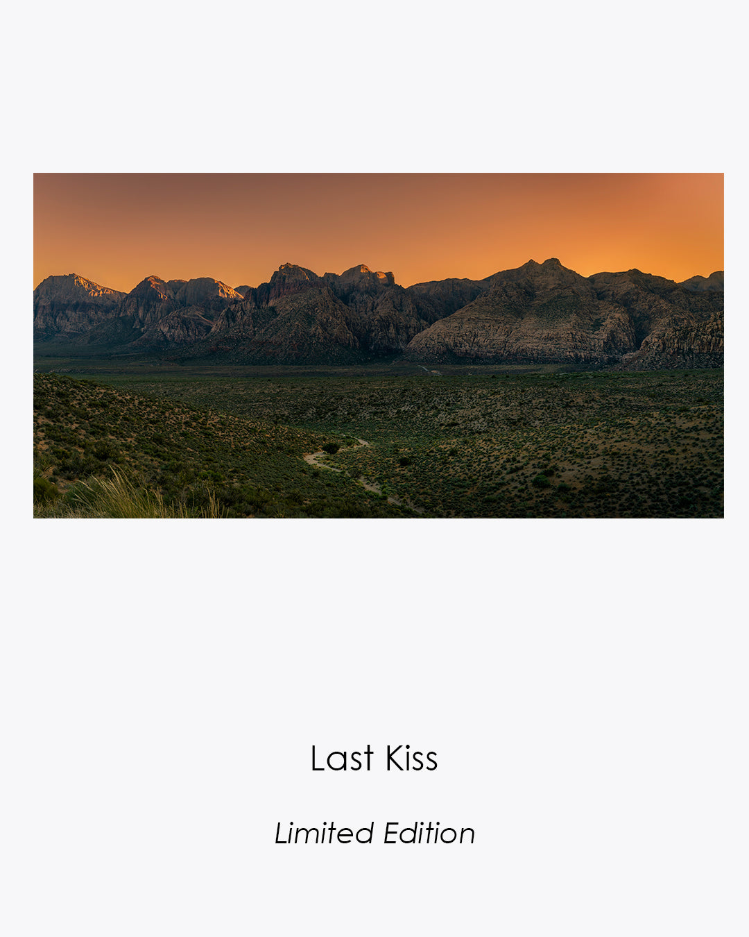 Last Kiss fine art photograph of sunlit red sandstone mountains in Red Rock Canyon, Nevada.