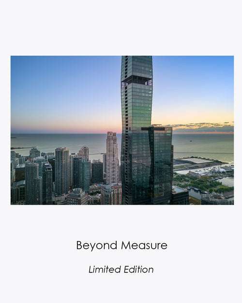 Beyond Measure fine art aerial photograph of the Chicago skyline and a glass tower rising beyond the frame at sunrise.