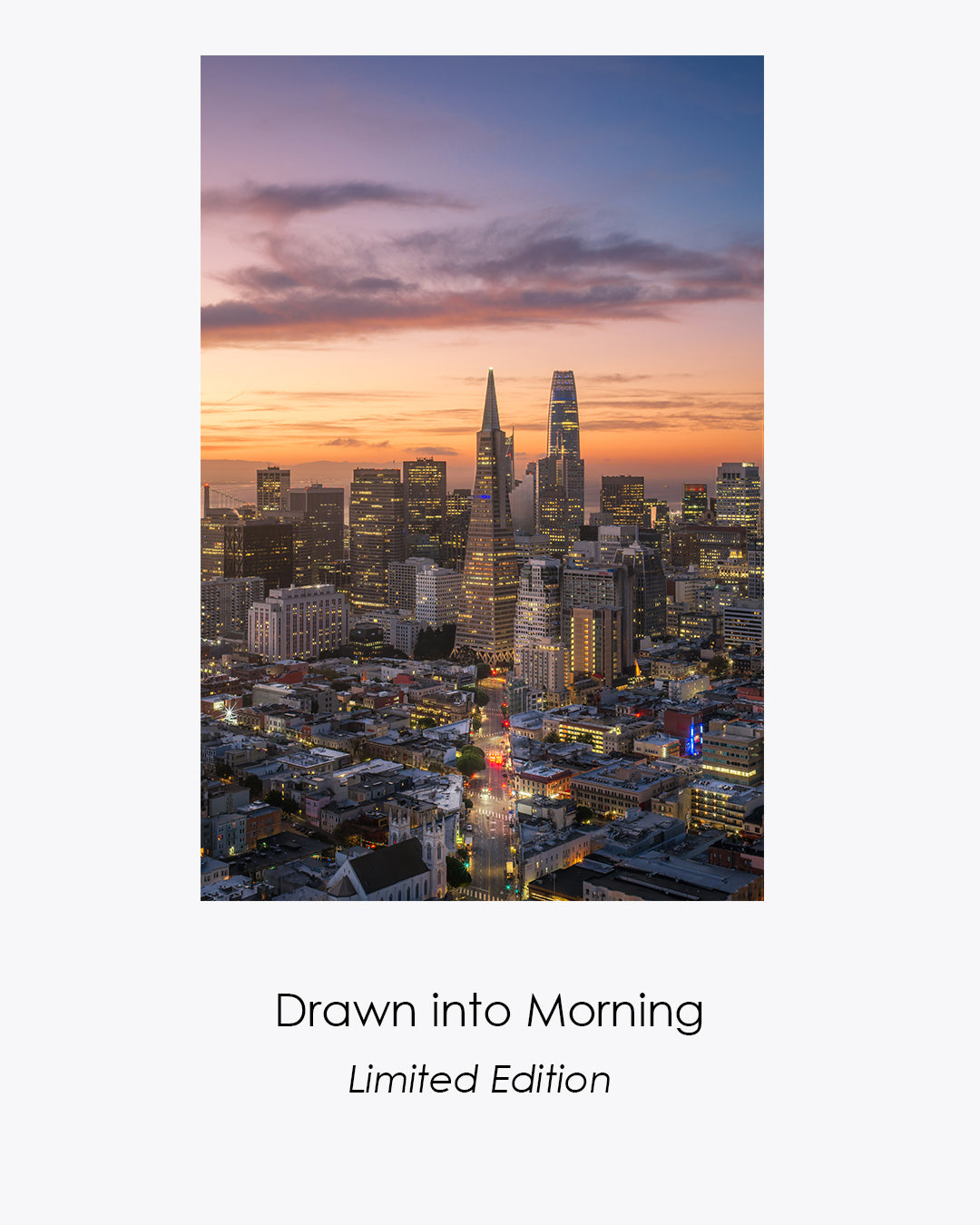Drawn Into Morning, a vertical aerial view of San Francisco at sunrise with Columbus Avenue leading toward the illuminated downtown skyline.