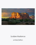 Courthouse Butte glowing in golden evening light beneath a dramatic blue-gray Sedona sky.