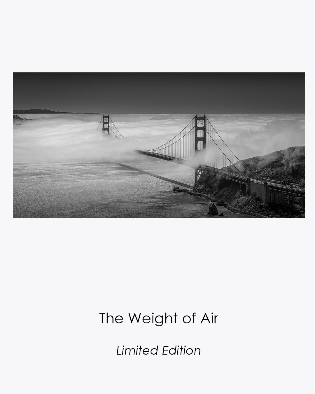 The Weight of Air, a black-and-white aerial view of the Golden Gate Bridge emerging through rolling San Francisco fog.