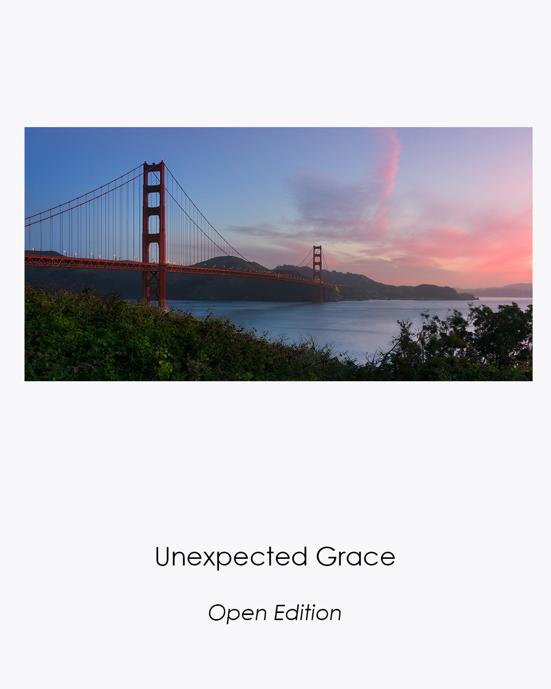 Unexpected Grace open-edition fine art photograph of the Golden Gate Bridge beneath soft blue and rose morning clouds.