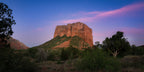 Panoramic photograph of Courthouse Butte beneath a sweeping rose-and-lavender cloud as the Sedona landscape settles into dusk.