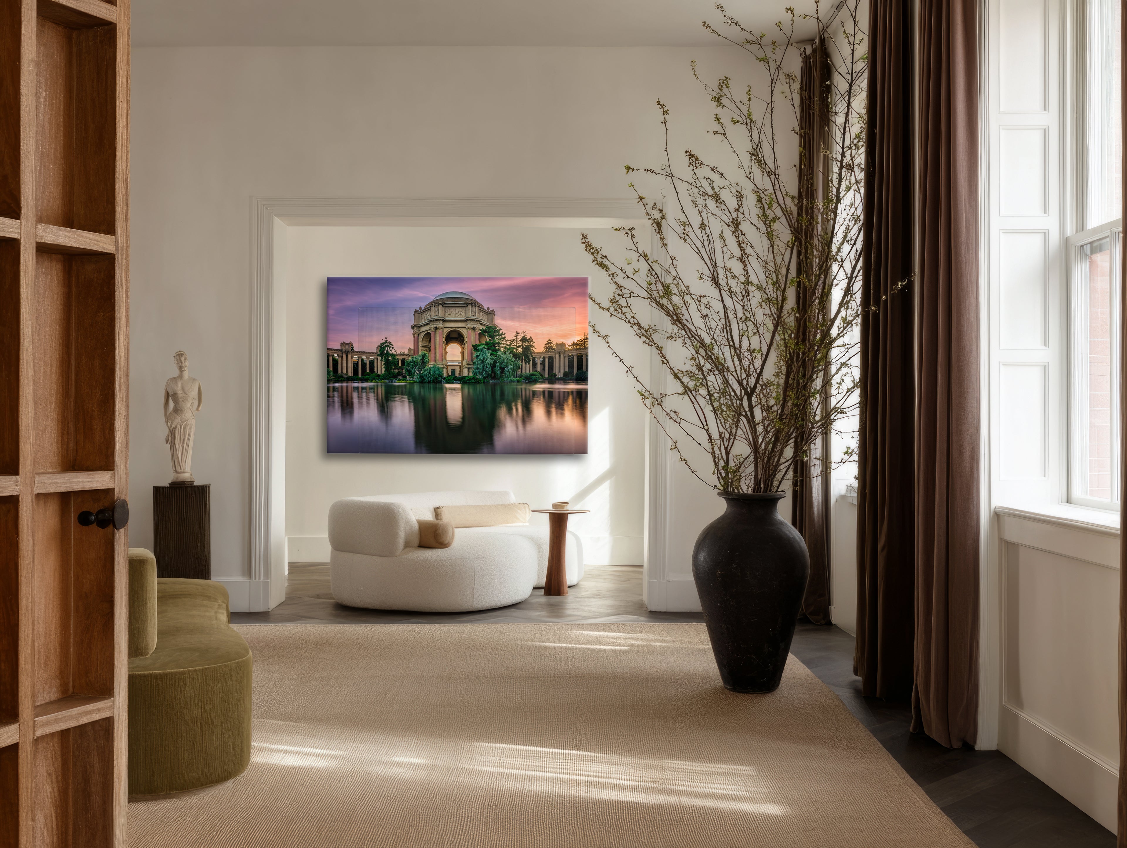 Sanctuary displayed as large-format acrylic fine art above a cream lounge chair in an elegant neutral interior.