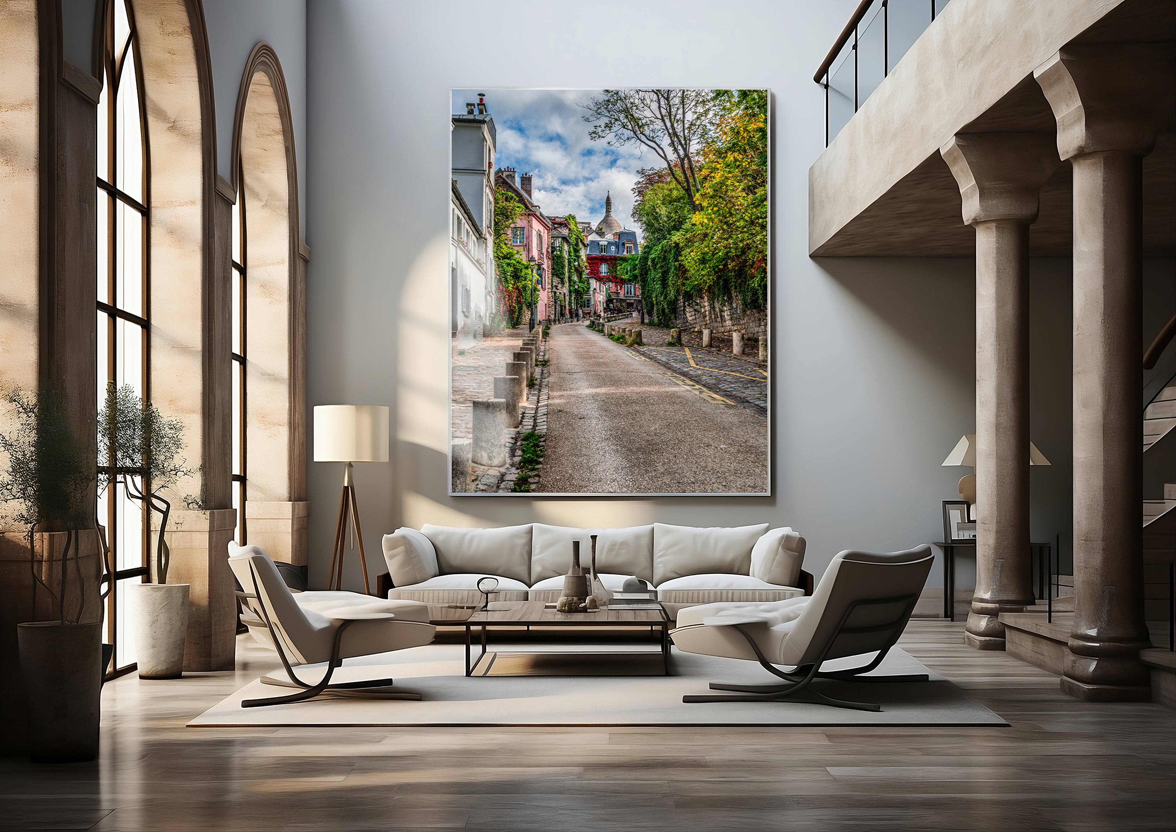 Large-format vertical photograph of a quiet Montmartre street displayed above white seating in a luxury hotel interior.