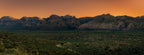 The final warm light of sunset illuminating the mountains and desert landscape of Red Rock Canyon, Nevada.