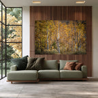 A Pause in Gold, a photograph of golden aspens displayed above a green sofa in a contemporary living room.