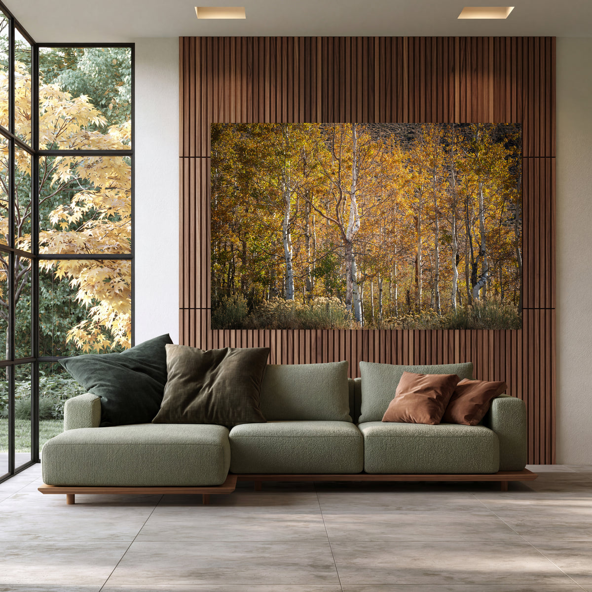 A Pause in Gold, a photograph of golden aspens displayed above a green sofa in a contemporary living room.
