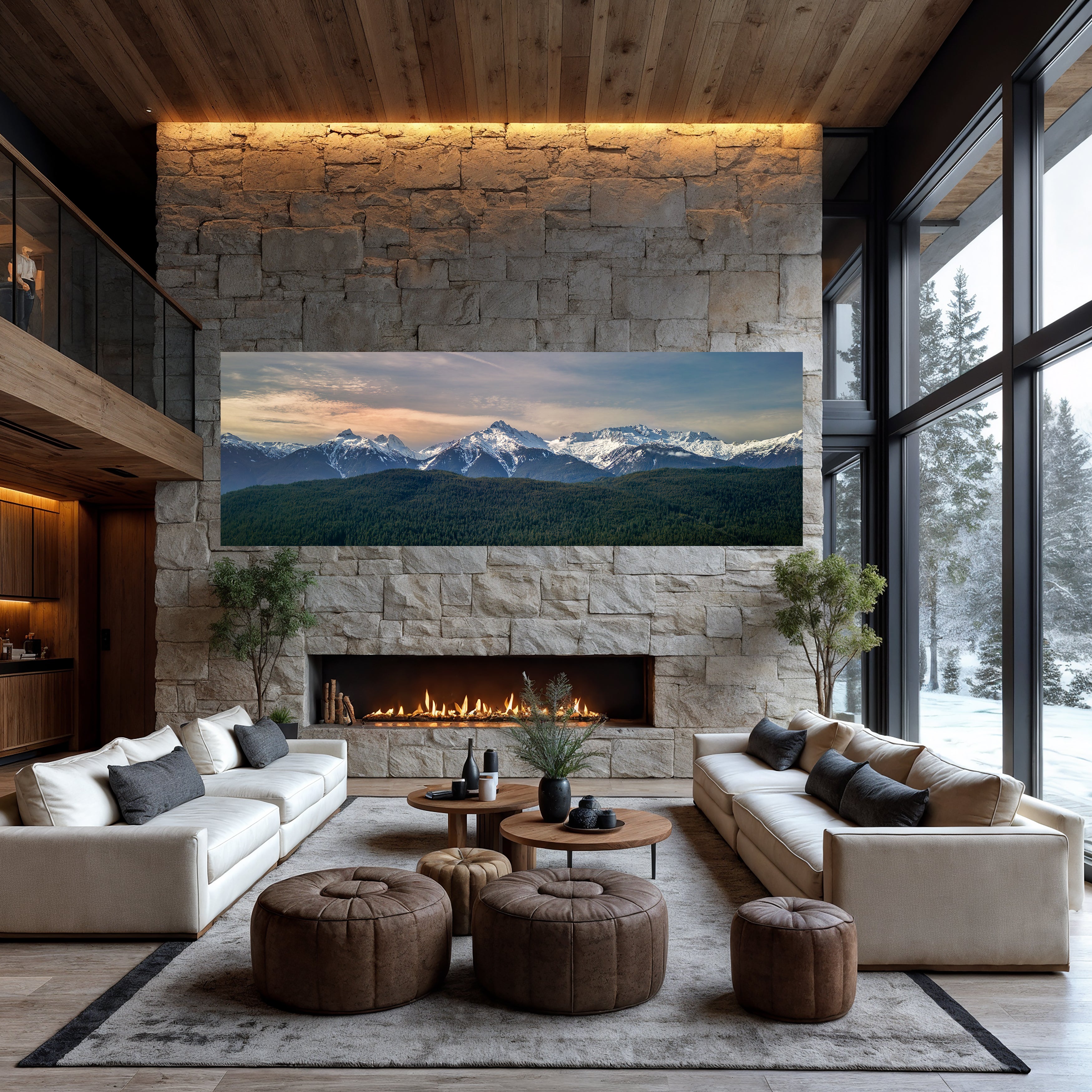 Stillness Ascending panoramic mountain photograph displayed above a stone fireplace in a contemporary lodge with snowy forest views.