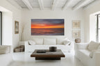 Sunset Bloom displayed as large-format acrylic fine art above a white sofa in a serene neutral living room.